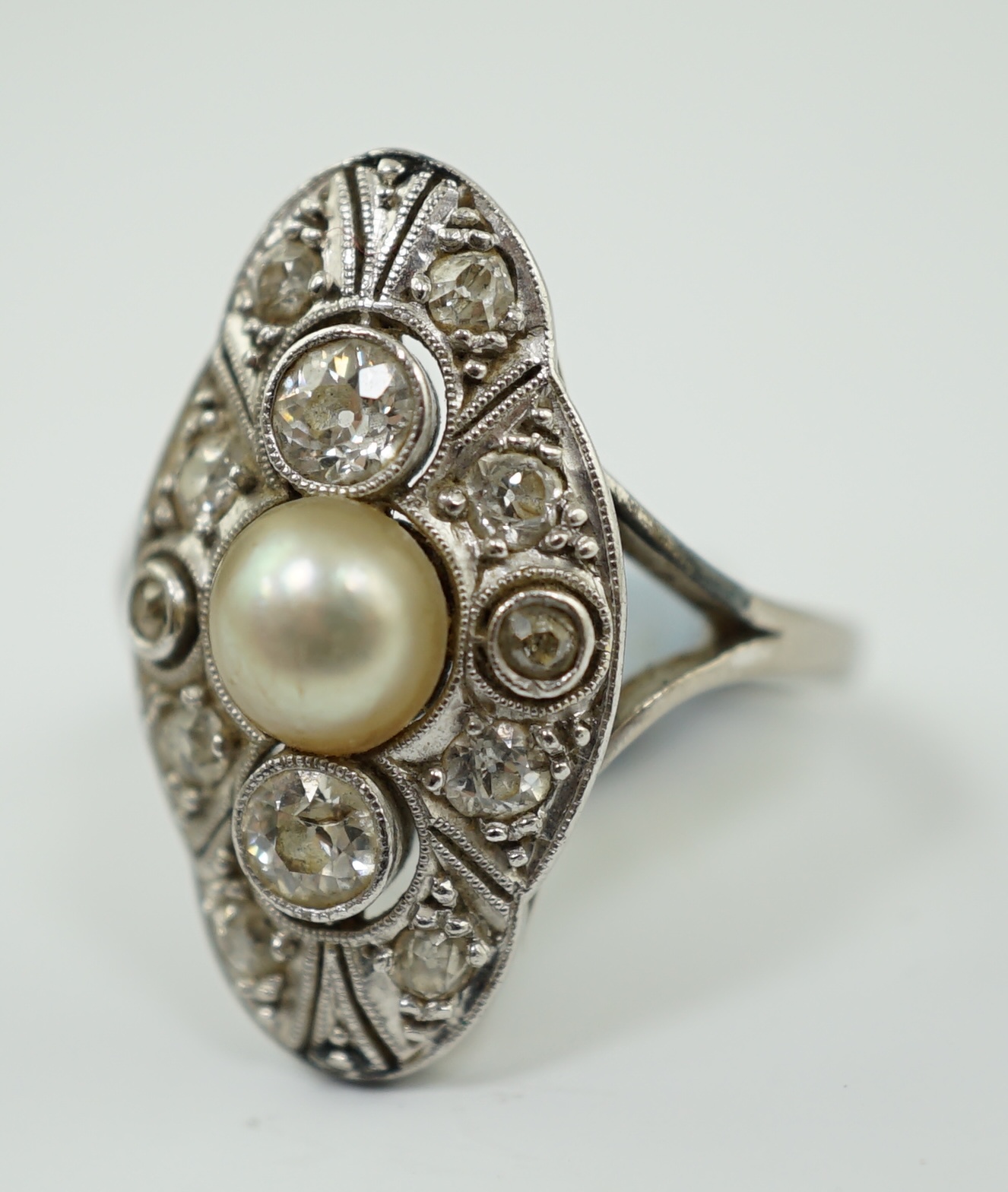 A Belle Epoque 18ct white gold, single stone split pearl and millegrain set diamond cluster lozenge shaped dress ring